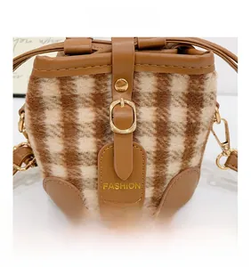 Detail showing vintage checkered velvet bucket bag with PU leather trim and metal buckles