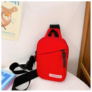 Detail of red canvas kids chest bag featuring adjustable black strap and sturdy buckle