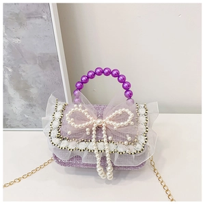 Detailed view of purple tweed girls bag with pearl bow handle and lace trim detail