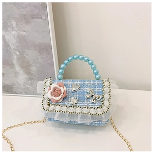 Detail of light blue girls' crossbody bag with flower charms and pearl handle