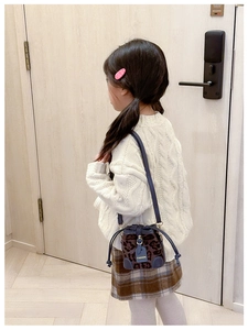 Detailed back view of a child wearing a stylish leopard print bucket bag with drawstring