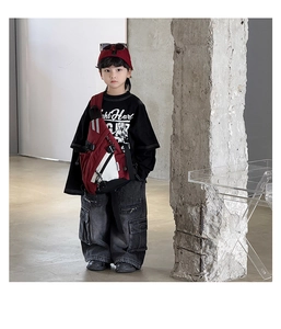 Detail of red and black functional crossbody chest bag for kids in a trendy street style look