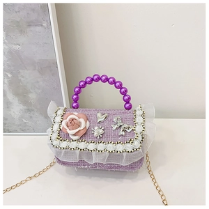 Detail of purple tweed girls handbag with pearl handle, floral lace and chain strap