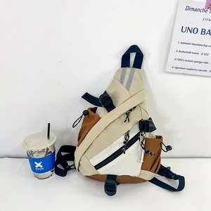 Detail of color-block kids crossbody bag with functional buckles and nylon texture