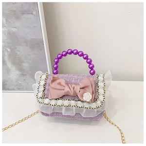 Detailed view of kids purple tweed bag with large pink bow and pearl bead handle