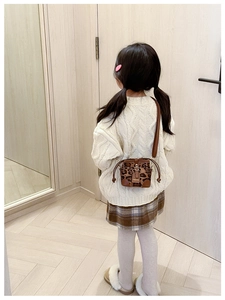 Kid's leopard print bucket crossbody bag with brown leather base and adjustable strap