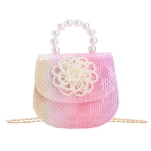 Pink gradient girls handbag with pearl flower detail and pearl handle on white background