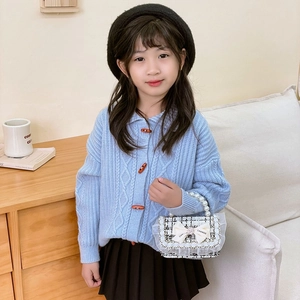 Girl's blue knit cardigan with toggle buttons and white checkered pearl handbag