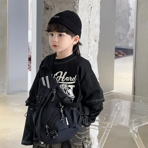 Fashionable kids black crossbody bag styled with street fashion and camo cargo shorts