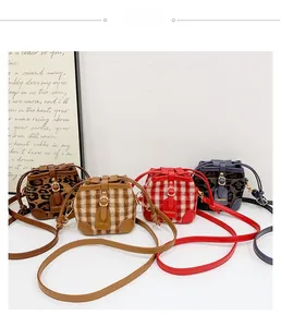 Detailed view of mini plush bucket bags in leopard print and vintage plaid patterns