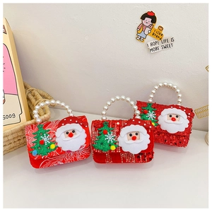Close-up of kids Christmas sequin mini bags with Santa designs and pearl handles
