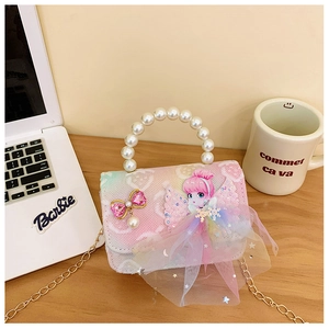 Close-up of pink gradient children bag with pearl handle and rhinestone bow charm detail