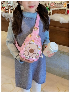 Detailed view of pink Capybara kids crossbody bag with adjustable strap on a young model