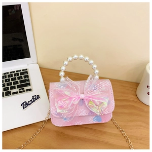 Detail of pink gradient kids bag featuring a pearl handle and large organza bow