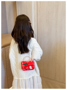 Detail of red festive children bag with 3D bunny, pearl handle and silver chain strap