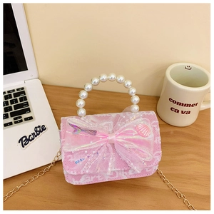 Detail of pink sequin handbag with large organza bow, pearl handle and mermaid charm