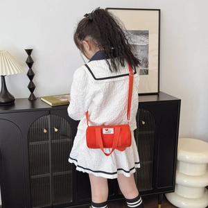 Red canvas bucket bag for kids with adjustable strap and chic letter patch