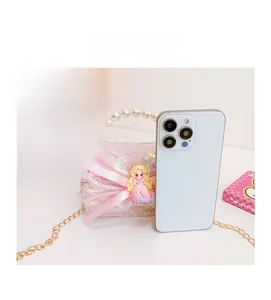 Detail view of mini sequin bag with pearl handle compared to a smartphone for size scale