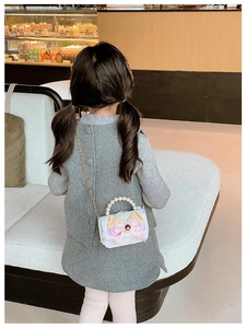Detailed view of kids crossbody bag with pearl handle, bow, and cartoon princess doll