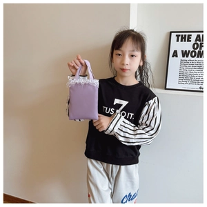 Detail of lavender fabric handbag with white lace trim held by a child model