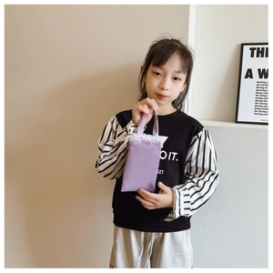 Detailed view of kids purple candy-colored handbag with elegant white lace trim