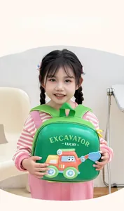 Detail view of a green excavator-themed hardshell backpack worn by a small child
