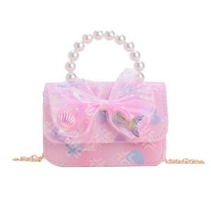 Pink kids handbag with heart pattern, large translucent bow and pearl handle on white background