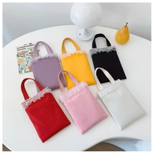 Selection of colorful candy-colored girls' mini lace handbags arranged on a table