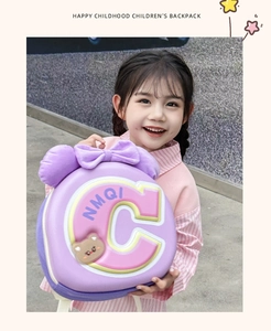 Pink and purple kids shell backpack with plush bow and bear badge held by a girl