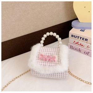 Détail du sac en tweed rose à carreaux avec fourrure, poignée perle et décor fleuri