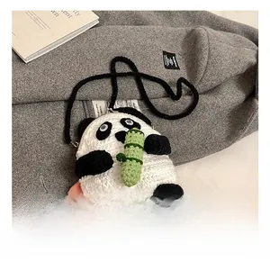 Detail of handmade crochet panda bag showing soft cotton texture and bamboo decor