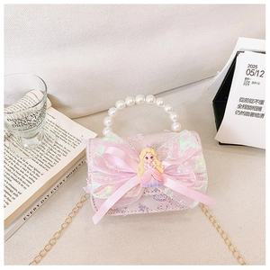 Detailed close-up of pink girls handbag featuring a large bow and pearl handle