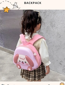 Pink EVA hard shell toddler backpack with cute puppy design shown on a young girl
