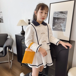 Elegant ivory textured two-piece skirt set for girls with navy trim and gold buttons