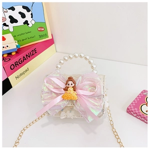 Detailed view of kids sequin handbag with large bow, princess doll and pearl handle