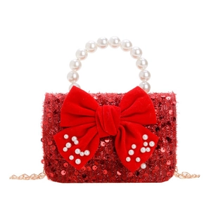 Festive red sequin children's handbag with large velvet bow and pearl handle