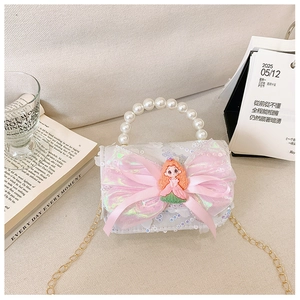 Detail view of girl's sequin handbag with a pink bow and pearl handle on light background