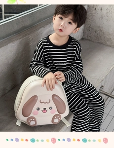 Detailed view of the cute beige puppy hardshell backpack on a toddler in a modern setting