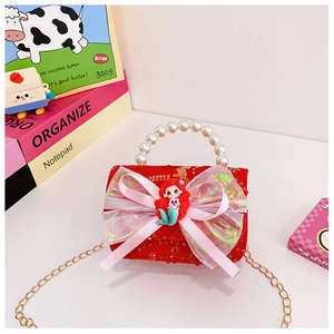 Close-up of girls' red sequin bag with pearl handle and iridescent pink bow detail