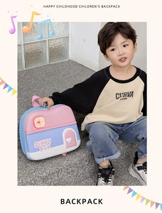 Toddler wearing a cute house-shaped cartoon backpack with Sunny Day print and pink handle