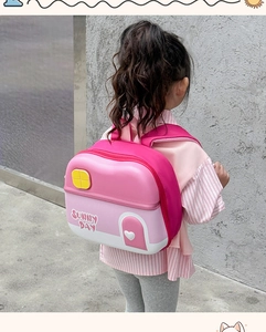 Detailed view of pink house-shaped backpack with sunny day text and heart detail
