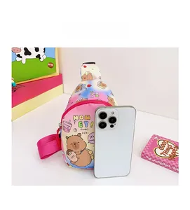 Detailed size comparison of pink bear print crossbody bag next to a smartphone