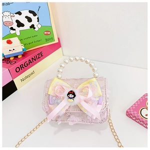 Detailed close-up of pink lace girl's handbag with pearl handle and ribbon bow