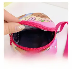 Internal structure of the pink cartoon chest bag showing a deep blue compartment and zipper