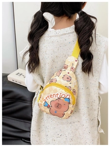 Child wearing a beige capybara crossbody bag with yellow strap and checkered print