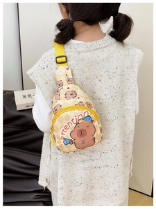 Child wearing cartoon capybara chest bag with yellow straps and checkered pattern