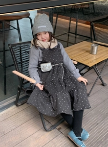 Outdoor styling of a child wearing a silver quilted chain waist bag and winter outfit