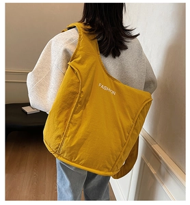 Rear view of a yellow oversized fashion tote bag showing capacity and lightweight style