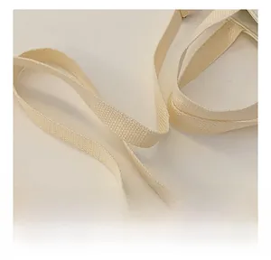 Detailed macro view of the beige woven canvas shoulder strap with cross-texture