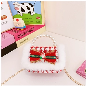 Detail of red plaid kids bag with white pearl handle and Christmas bow decoration